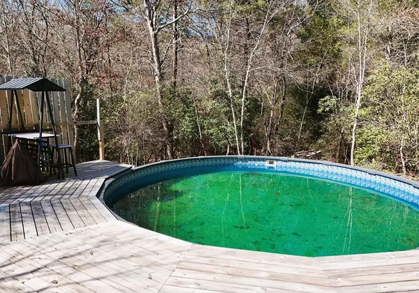 a view of a backyard with swimming pool