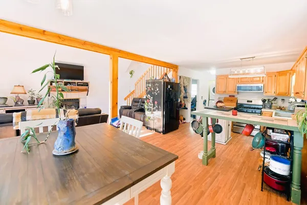 a living room with lots of furniture and kitchen view