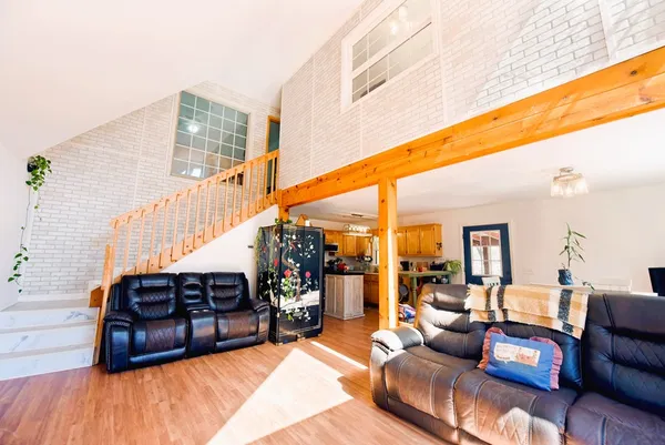 a living room with furniture and wooden floor