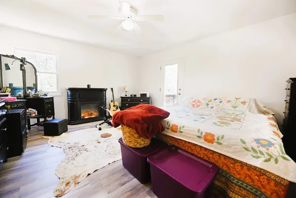 a bedroom with a bed and wooden floor