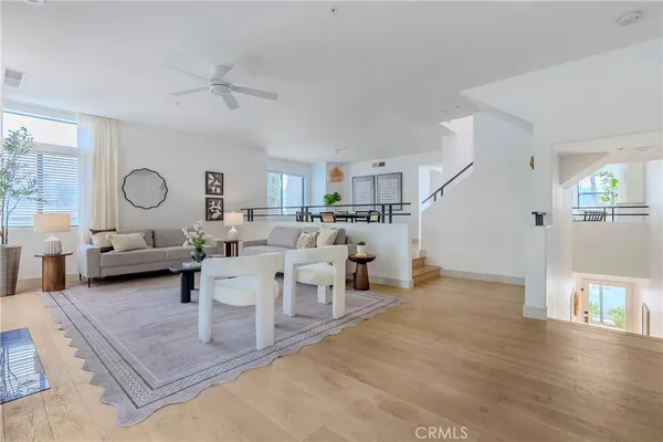 a living room with lots of furniture and view of kitchen
