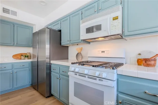 a kitchen with stainless steel appliances granite countertop cabinets and a stove top oven