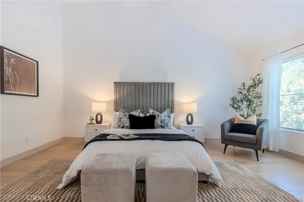 a bedroom with a bed and a couch