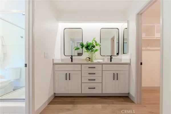 a bathroom with a double vanity sink and a mirror