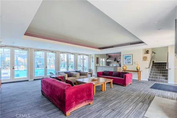 a living room with furniture and a floor to ceiling window