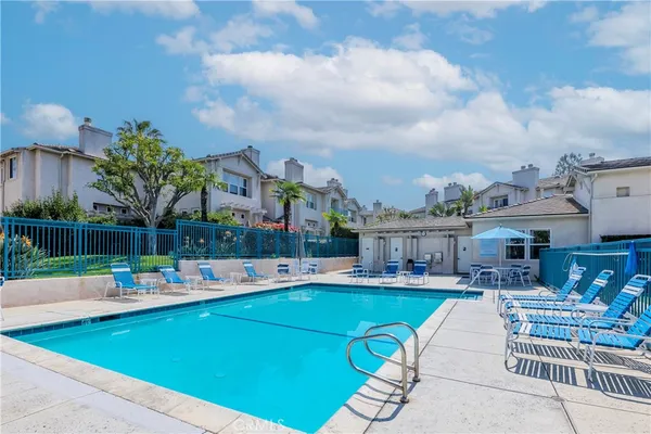 a view of a swimming pool with outdoor seating