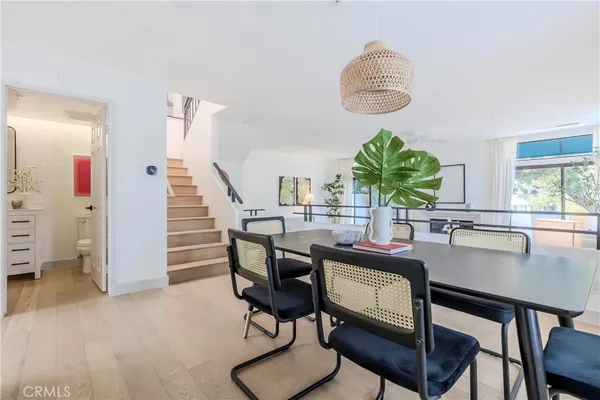 a dining room with furniture and a window