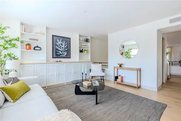 a living room with furniture and painting on the wall