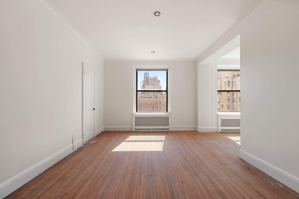 920 5th Avenue, Unit 10B Manhattan, NY 10021 - Photo 15 of 23 an empty room with wooden floor and windows