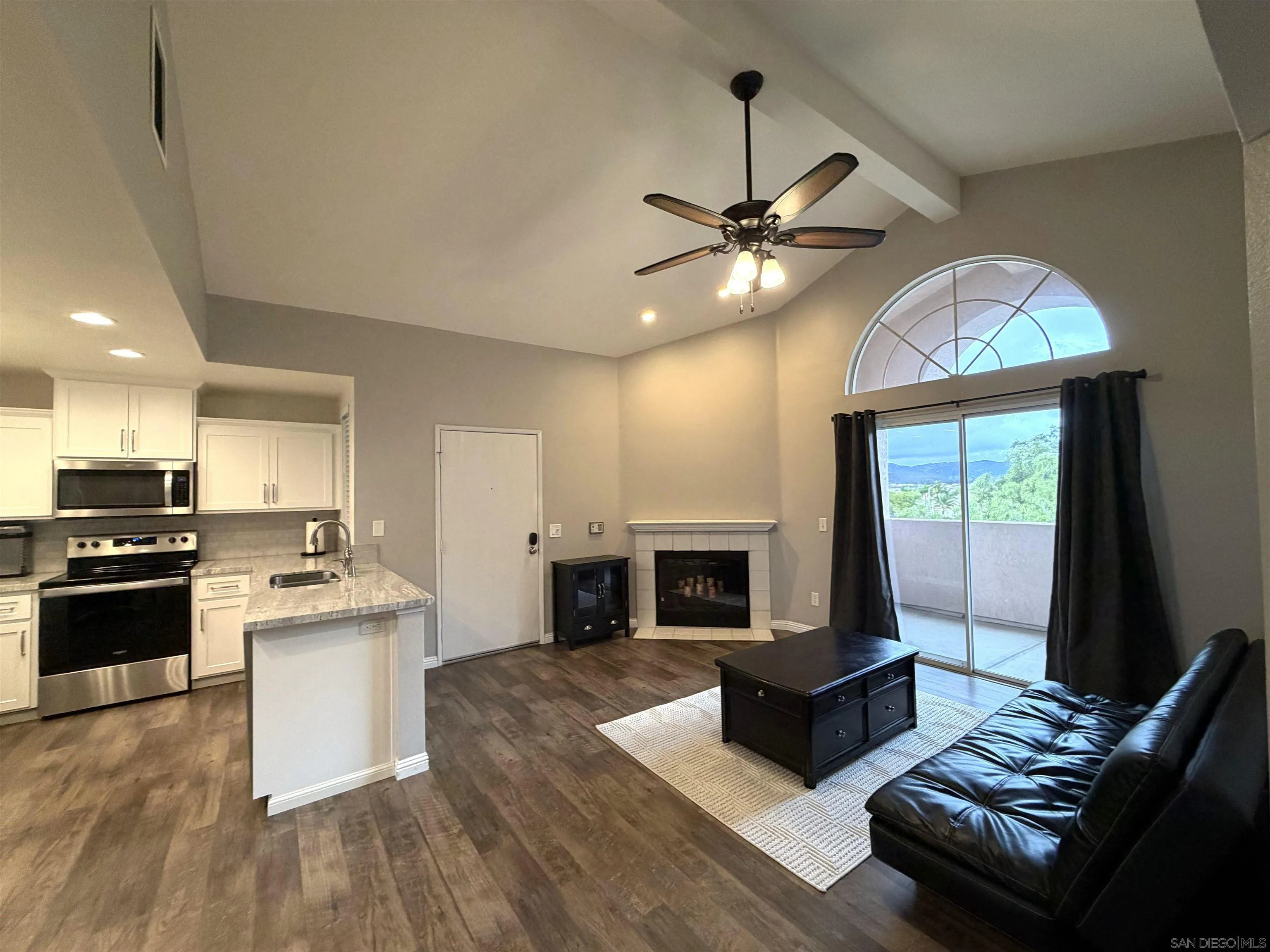 17161 Alva Road, Unit 123 San Diego, CA 92127 - Photo 14 of 30 a living room with stainless steel appliances kitchen island granite countertop furniture and a fireplace