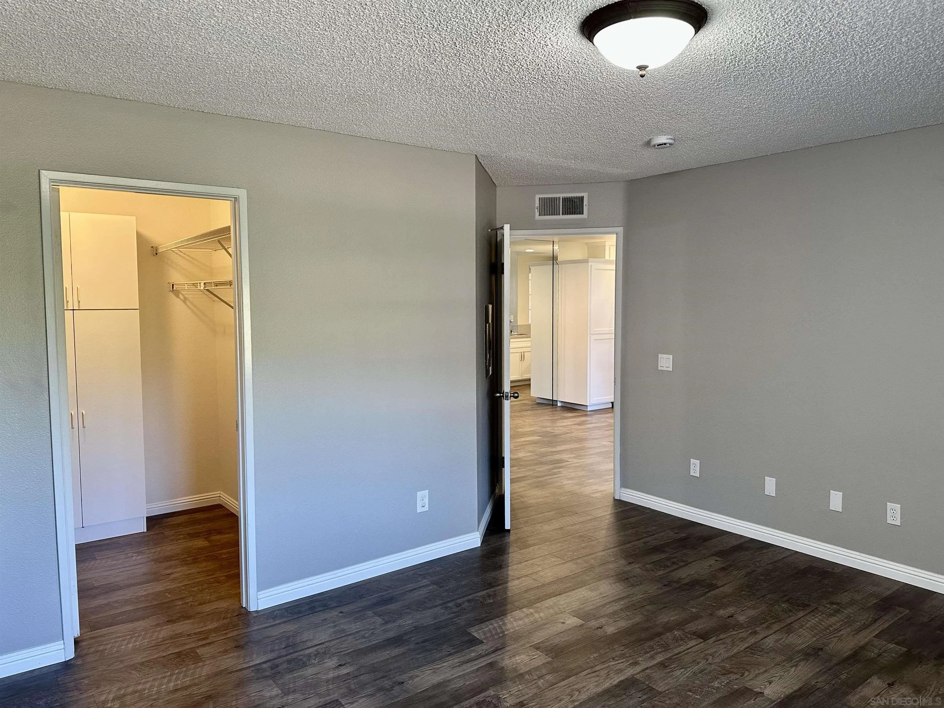 17161 Alva Road, Unit 123 San Diego, CA 92127 - Photo 19 of 30 an empty room with wooden floor and windows