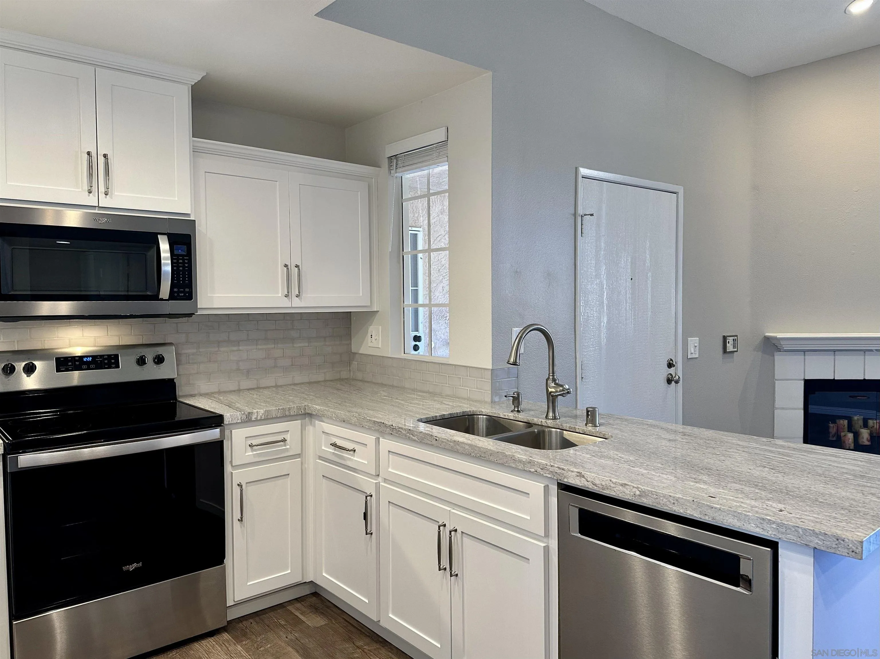 17161 Alva Road, Unit 123 San Diego, CA 92127 - Photo 4 of 30 a kitchen with stainless steel appliances granite countertop a stove a sink and a microwave