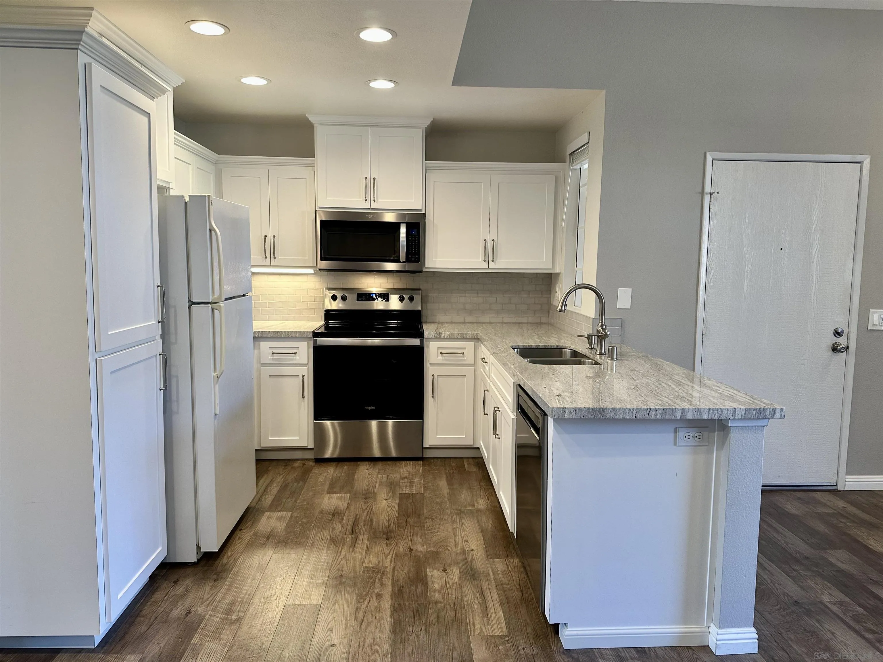 17161 Alva Road, Unit 123 San Diego, CA 92127 - Photo 5 of 30 a kitchen with a sink a counter top space stainless steel appliances and cabinets