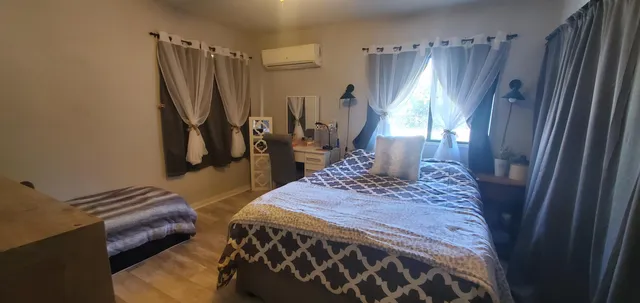 a bedroom with a bed and a mirror