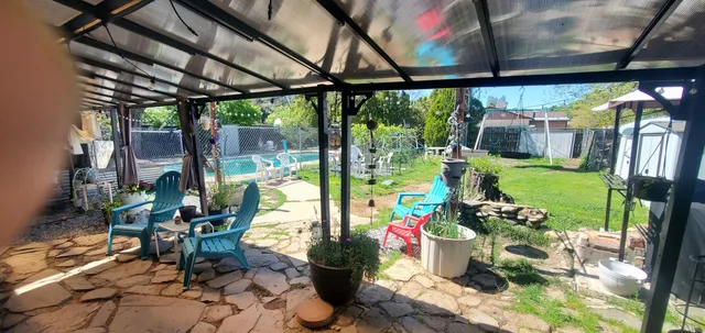 a view of a porch with dining table and chairs