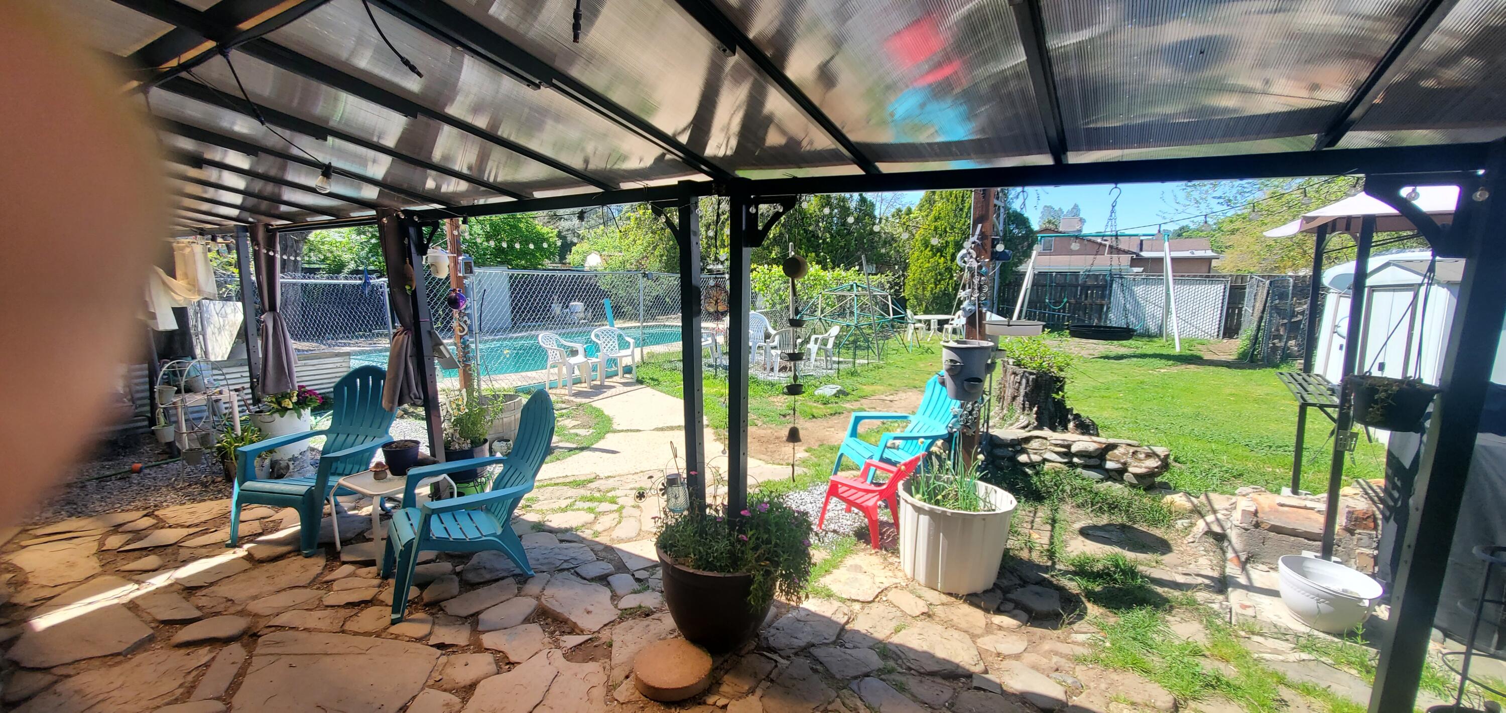 19368 Lucille Street Anderson, CA 96007 - Photo 8 of 13 a view of a porch with dining table and chairs