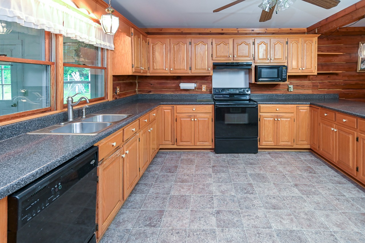 855 Hickory Drive Pulaski, TN 38478 - Photo 11 of 57 a kitchen with granite countertop a stove a sink and a refrigerator