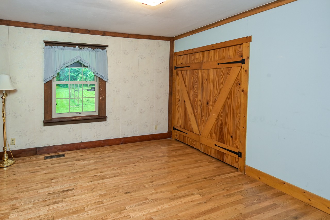 855 Hickory Drive Pulaski, TN 38478 - Photo 8 of 57 a view of an empty room with wooden floor and a window