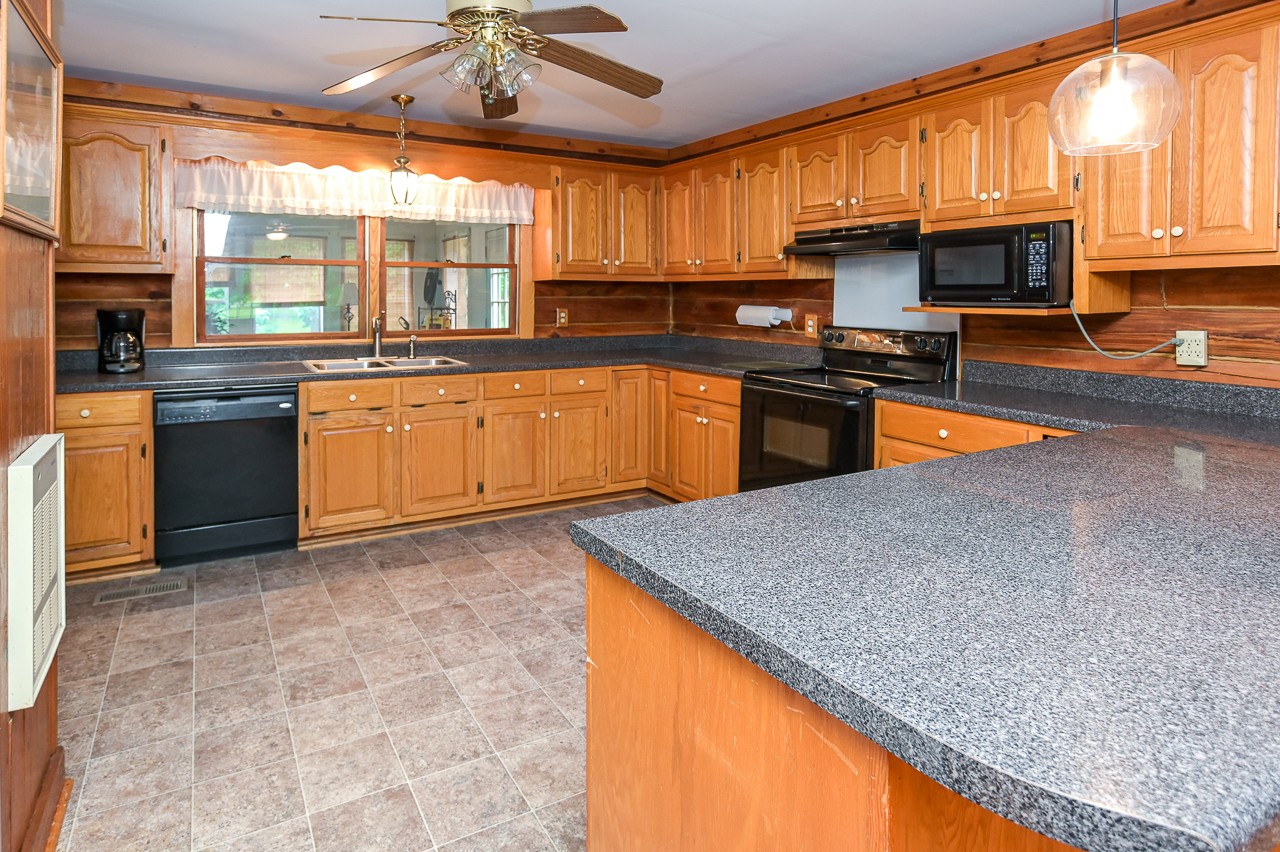 855 Hickory Drive Pulaski, TN 38478 - Photo 10 of 57 a kitchen with stainless steel appliances granite countertop a stove a sink and a microwave