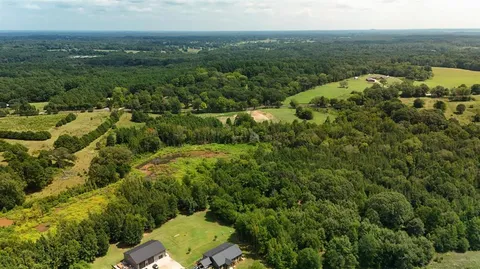 an aerial view of a houses with a yard