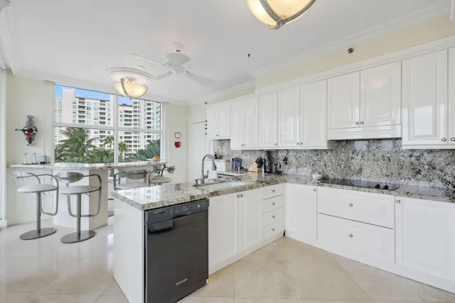 a kitchen with stainless steel appliances a table and chairs in it