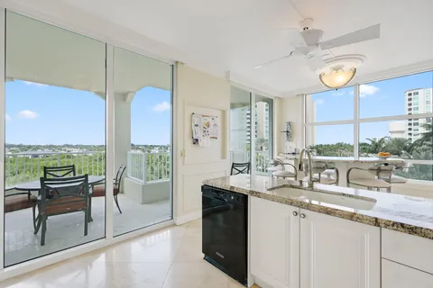 a dining room with furniture and a floor to ceiling window