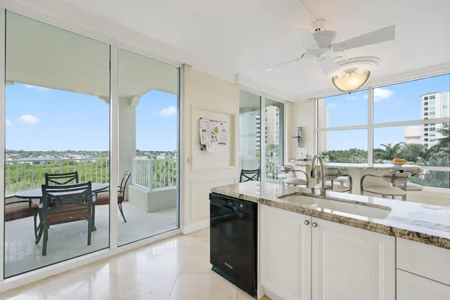 a dining room with furniture and a floor to ceiling window