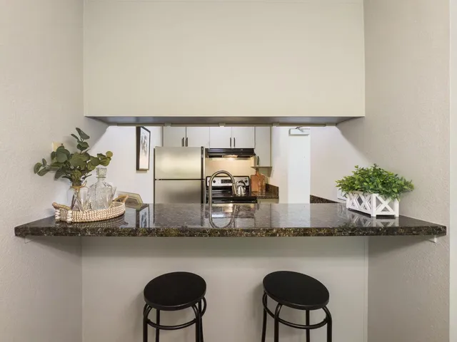 a kitchen with a table and chairs