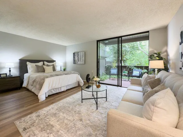 a bedroom with a bed and large window