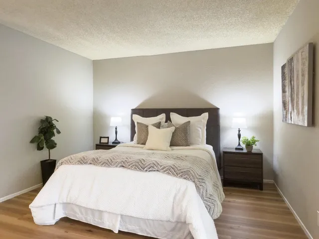 a bedroom with a bed and lamps