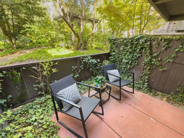 a backyard of a house with table and chairs