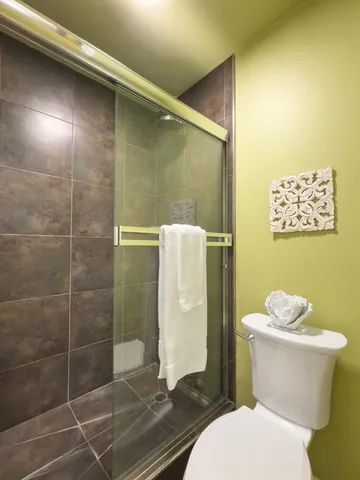 a white toilet sitting next to a bathroom sink