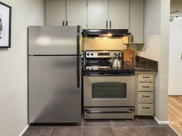 a kitchen with appliances cabinets and a counter