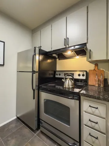 a kitchen with granite countertop cabinets and steel stainless steel appliances