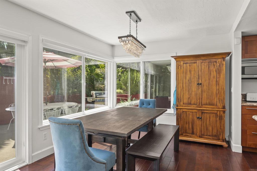 3099 Driscoll Drive San Diego, CA 92117 - Photo 14 of 41 a view of a dining room with furniture window and wooden floor