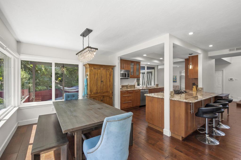 3099 Driscoll Drive San Diego, CA 92117 - Photo 16 of 41 a view of a dining room with furniture window and wooden floor
