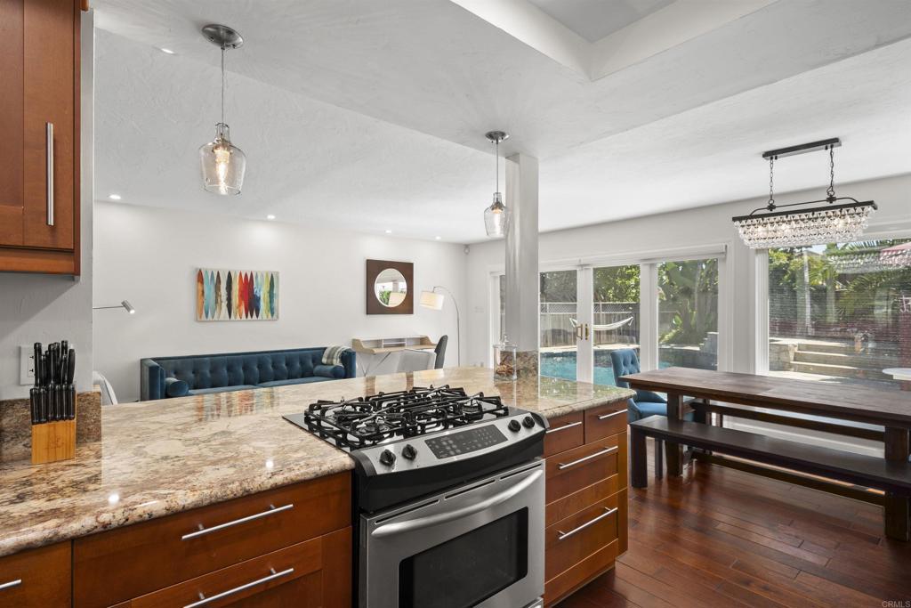 3099 Driscoll Drive San Diego, CA 92117 - Photo 19 of 41 a kitchen with a stove a sink and wooden floor