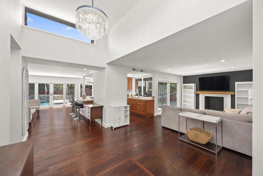3099 Driscoll Drive San Diego, CA 92117 - Photo 21 of 41 a living room with fireplace furniture and a wooden floor