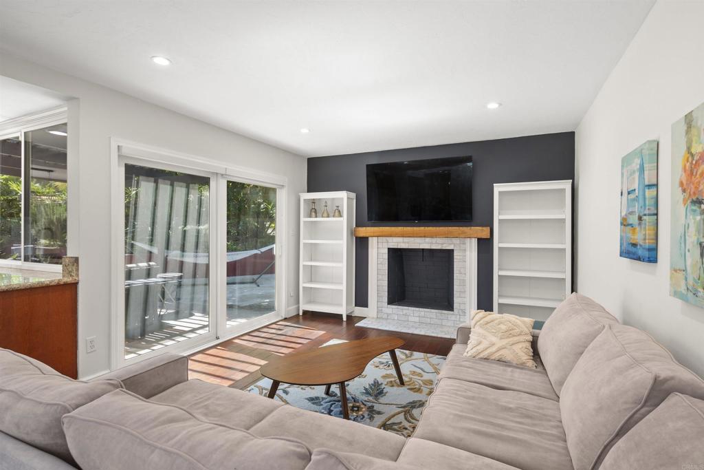3099 Driscoll Drive San Diego, CA 92117 - Photo 23 of 41 a living room with a fireplace and a flat screen tv
