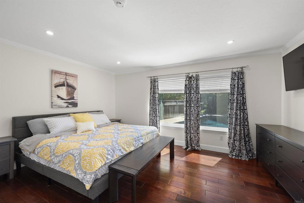3099 Driscoll Drive San Diego, CA 92117 - Photo 25 of 41 a bedroom with a large bed and a large window