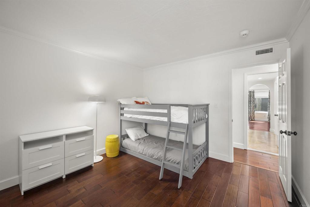 3099 Driscoll Drive San Diego, CA 92117 - Photo 32 of 41 a bedroom with furniture and a wooden floor