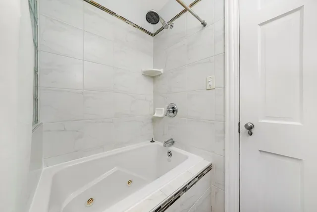 a bathroom with a bathtub and shower