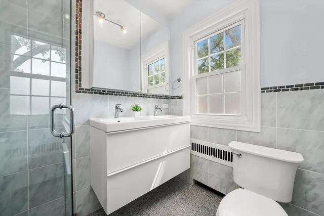 a bathroom with a sink toilet and shower