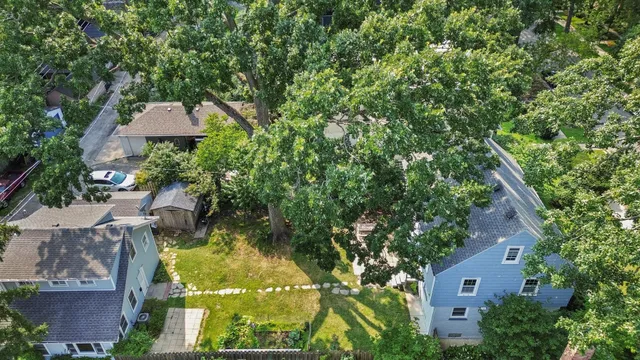 an aerial view of a house with swimming pool and garden