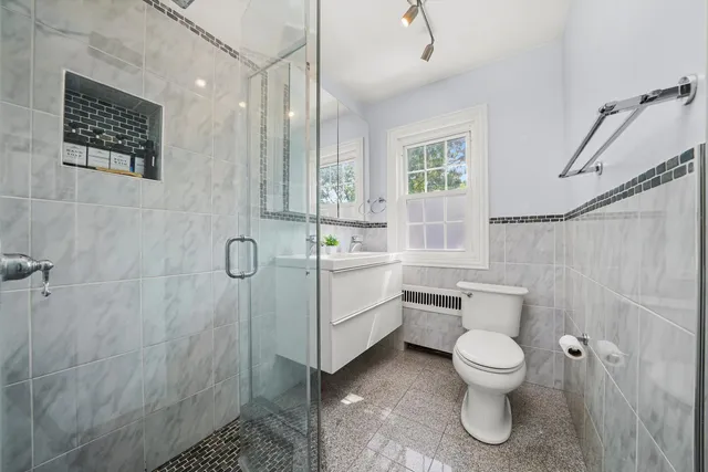 a bathroom with a toilet sink and shower