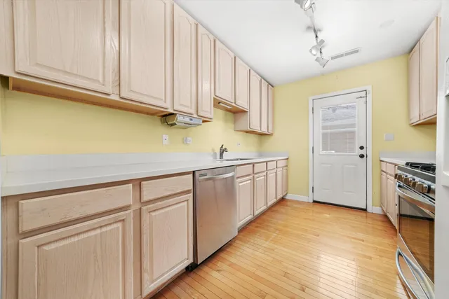 a kitchen with stainless steel appliances granite countertop a sink and cabinets