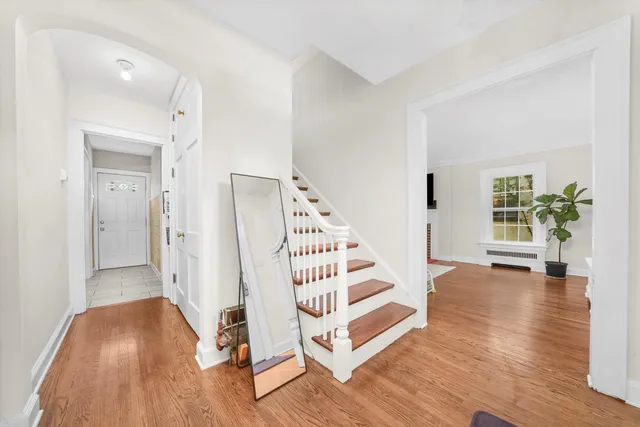 a view of entryway with wooden floor and stairs