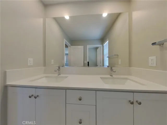 a bathroom with a double vanity sink and a mirror