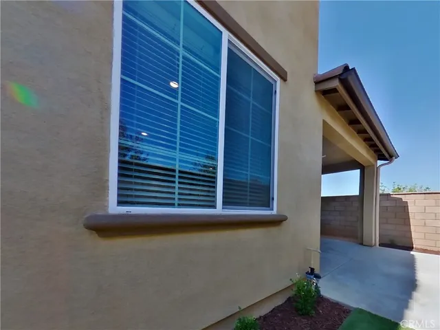 a view of empty room with wooden floor and windows