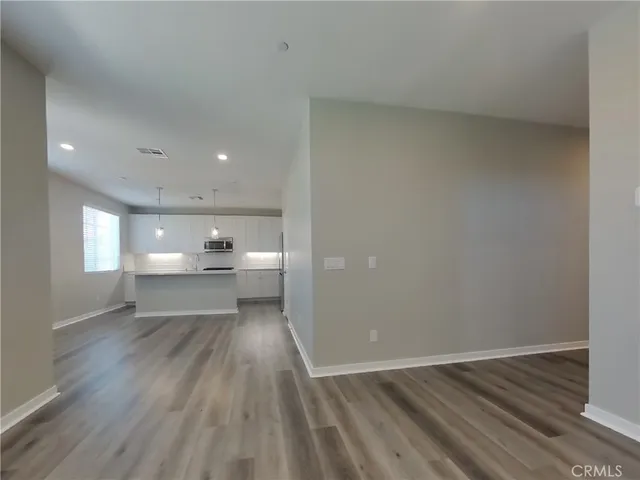 a view of a kitchen with wooden floor